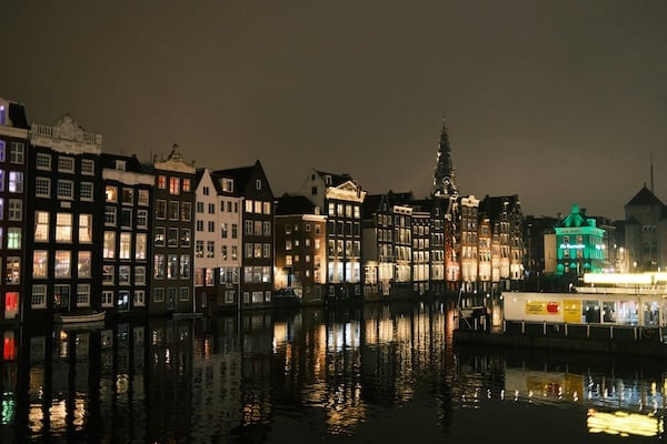 Amsterdam waterfront buildings at night.
