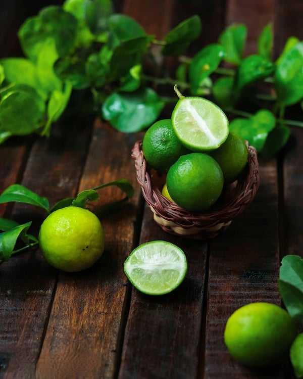 bright green limes on a wooden table